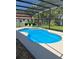 Backyard pool with a hot tub, screened-in enclosure and view of the lush landscaping at 5416 Bay Side Dr, Orlando, FL 32819