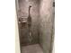 An elegant glass-enclosed shower stall featuring decorative marble-look tile and modern fixtures at 5416 Bay Side Dr, Orlando, FL 32819