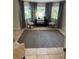 Cozy sitting room featuring neutral furnishings and views of the outdoor landscape at 5416 Bay Side Dr, Orlando, FL 32819