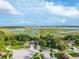 A charming home in a suburban neighborhood near a lake surrounded by beautiful scenery from an aerial perspective at 544 Lake Sumner Dr, Groveland, FL 34736