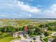 Scenic aerial view of the property with a lake in the background at 544 Lake Sumner Dr, Groveland, FL 34736