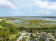 Beautiful aerial view of a suburban home near a serene lake and lush green surroundings on a sunny day at 544 Lake Sumner Dr, Groveland, FL 34736