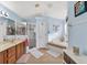 Bright bathroom featuring a shower, separate tub, and tiled floors at 544 Lake Sumner Dr, Groveland, FL 34736