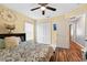 Bright bedroom with hardwood floors, ceiling fan, large closet and natural light at 544 Lake Sumner Dr, Groveland, FL 34736