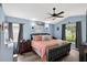 Cozy bedroom with vaulted ceiling, ceiling fan, and comfortable bed at 544 Lake Sumner Dr, Groveland, FL 34736