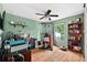 Inviting bedroom featuring a ceiling fan, wood floors, and a bright window for a comfortable living space at 544 Lake Sumner Dr, Groveland, FL 34736