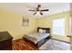 Comfortable bedroom with hardwood floors, ceiling fan, and natural light at 544 Lake Sumner Dr, Groveland, FL 34736