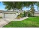 Beautiful single-story home showcasing lush green landscaping and a two-car garage at 544 Lake Sumner Dr, Groveland, FL 34736