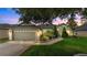 Charming single-story home featuring a well-manicured lawn and an attached two-car garage at 544 Lake Sumner Dr, Groveland, FL 34736