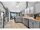 Bright kitchen with stainless steel appliances and light gray cabinets and ample counter space at 544 Lake Sumner Dr, Groveland, FL 34736