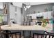 Kitchen with a bar, counter seating, stainless steel appliances and modern lighting fixtures at 544 Lake Sumner Dr, Groveland, FL 34736