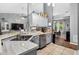 Open concept kitchen featuring stainless steel appliances, granite countertops, and an eat-in area at 544 Lake Sumner Dr, Groveland, FL 34736