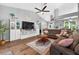 Bright living area featuring a plush sofa, a ceiling fan, and lots of natural light at 544 Lake Sumner Dr, Groveland, FL 34736