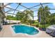 Sparkling screened-in pool with lush landscaping offering a serene outdoor retreat at 544 Lake Sumner Dr, Groveland, FL 34736
