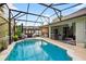 Inviting screened-in pool, spa, and outdoor dining with scenic backyard views at 544 Lake Sumner Dr, Groveland, FL 34736