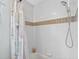 Clean shower featuring white tile and a shower head with detachable hose at 544 Lake Sumner Dr, Groveland, FL 34736