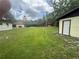 Expansive backyard with lush green grass, mature trees, and a detached shed at 5935 Sheryl Anita St, Oviedo, FL 32765