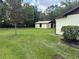 Spacious backyard with lush green grass, mature trees, and a detached shed at 5935 Sheryl Anita St, Oviedo, FL 32765