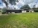 The home has a spacious backyard with mature trees and a screened in porch at 5935 Sheryl Anita St, Oviedo, FL 32765