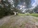 Expansive backyard with mature trees and a storage shed offers privacy and outdoor enjoyment at 5935 Sheryl Anita St, Oviedo, FL 32765