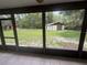View from the screened-in porch of a spacious backyard and shed at 5935 Sheryl Anita St, Oviedo, FL 32765
