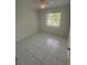 Clean bedroom with tiled floors, a ceiling fan, and natural light from the window at 5935 Sheryl Anita St, Oviedo, FL 32765