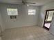 This bedroom features tile flooring, two windows and access to the outside screened in patio at 5935 Sheryl Anita St, Oviedo, FL 32765