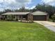 Charming single-story brick home featuring a lush green lawn and well-maintained landscaping at 5935 Sheryl Anita St, Oviedo, FL 32765