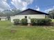 Exterior shot of home with brick accents, mature landscaping, and a well-maintained lawn at 5935 Sheryl Anita St, Oviedo, FL 32765