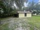 Detached shed with green siding and a lean-to structure, offering additional storage at 5935 Sheryl Anita St, Oviedo, FL 32765