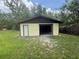 Detached shed with an open garage door and a side entry door at 5935 Sheryl Anita St, Oviedo, FL 32765