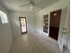Bright sunroom with tile flooring, ceiling fan, and access to the outside patio and living area at 5935 Sheryl Anita St, Oviedo, FL 32765
