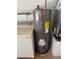 A Rheem water heater sits next to a washing machine, highlighting home utility features at 5935 Sheryl Anita St, Oviedo, FL 32765