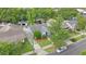 Aerial view of a charming blue home with a well-manicured lawn and mature trees at 638 Clayton St, Orlando, FL 32804