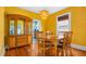 Bright dining room with hardwood floors, a modern light fixture, and a large china cabinet at 638 Clayton St, Orlando, FL 32804