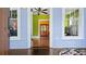 Welcoming entryway boasting beautiful hardwood floors and views of the living room with a green and orange color scheme at 638 Clayton St, Orlando, FL 32804