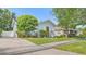 Light blue home featuring manicured landscaping and a charming front yard at 638 Clayton St, Orlando, FL 32804