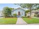 Charming light blue single-story home with well-manicured lawn and front yard at 638 Clayton St, Orlando, FL 32804