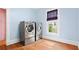 Well-lit laundry room featuring modern washer and dryer units, accented by a window with a shade at 638 Clayton St, Orlando, FL 32804