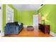 Living room boasting vibrant green walls, hardwood floors, and comfortable seating, creating a cozy atmosphere at 638 Clayton St, Orlando, FL 32804