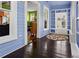 Sunroom featuring blue walls, hardwood floors and a view into the green-walled living room at 638 Clayton St, Orlando, FL 32804