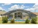 View of a beautiful screened in pool area, with a dining table and chairs for outdoor enjoyment at 8102 Pomo Dr, Kissimmee, FL 34747
