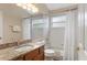 Bathroom features a shower, tub and vanity with a mirror, and granite countertops at 8102 Pomo Dr, Kissimmee, FL 34747