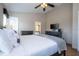 Bedroom features a ceiling fan, TV, and wood-look floors at 8102 Pomo Dr, Kissimmee, FL 34747