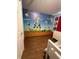 This themed bedroom features a playful mural and neutral furnishings at 8102 Pomo Dr, Kissimmee, FL 34747