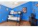 Bright blue bedroom features a bunk bed and themed decor at 8102 Pomo Dr, Kissimmee, FL 34747