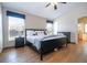 Spacious bedroom with a ceiling fan, wood-look floors, two large windows and two dressers at 8102 Pomo Dr, Kissimmee, FL 34747
