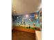 Bedroom with a playful video game theme and modern wood flooring at 8102 Pomo Dr, Kissimmee, FL 34747