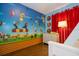 Bright bedroom with a Mario Bros themed wall covering, red curtains and hardwood floors at 8102 Pomo Dr, Kissimmee, FL 34747