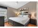 Bedroom features a queen bed, a ceiling fan, wood-look floors and large windows at 8102 Pomo Dr, Kissimmee, FL 34747